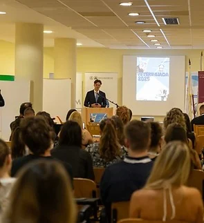 A speaker addressing an audience in a lecture hall of the Congress Center in Ohrid